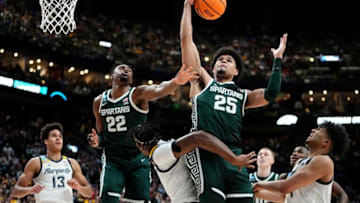 Mar 19, 2023; Columbus, Ohio, USA; Michigan State Spartans forward Malik Hall (25) grabs a rebound over Marquette Golden Eagles forward Olivier-Maxence Prosper (12) during the second round of the NCAA men’s basketball tournament at Nationwide Arena. Mandatory Credit: Adam Cairns-The Columbus DispatchBasketball Ncaa Men S Basketball Tournament Round 2