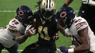 NEW ORLEANS, LOUISIANA - JANUARY 10: Alvin Kamara #41 of the New Orleans Saints runs the ball against Danny Trevathan #59 and Barkevious Mingo #50 of the Chicago Bears during the fourth quarter in the NFC Wild Card Playoff game at Mercedes Benz Superdome on January 10, 2021 in New Orleans, Louisiana. (Photo by Chris Graythen/Getty Images)