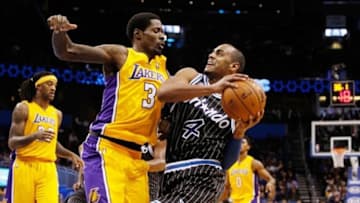 Jan 24, 2014; Orlando, FL, USA; Orlando Magic shooting guard Arron Afflalo (4) drives to the basket as he shoots over Los Angeles Lakers point guard Manny Harris (3) during the second half at Amway Center. Orlando Magic defeated the Los Angeles Lakers 114-105. Mandatory Credit: Kim Klement-USA TODAY Sports
