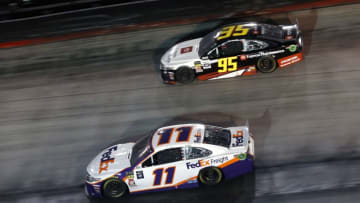 BRISTOL, TENNESSEE - AUGUST 17: Denny Hamlin, driver of the #11 FedEx Freight Toyota, races Matt DiBenedetto, driver of the #95 Toyota Express Maintenance Toyota, in the closing laps of the Monster Energy NASCAR Cup Series Bass Pro Shops NRA Night Race at Bristol Motor Speedway on August 17, 2019 in Bristol, Tennessee. (Photo by Brian Lawdermilk/Getty Images)