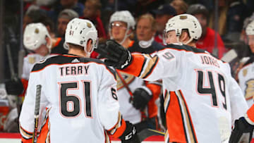 NEWARK, NJ - JANUARY 19: Troy Terry #61 of the Anaheim Ducks is congratulated by Max Jones #49 after scoring his first NHL goal against the New Jersey Devils during the game at Prudential Center on January 19, 2019 in Newark, New Jersey. (Photo by Andy Marlin/NHLI via Getty Images)
