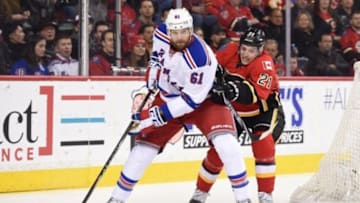 Dec 12, 2015; Calgary, Alberta, CAN; Calgary Flames left wing Mason Raymond (21) chases after New York Rangers left wing Rick Nash (61) during the first period at Scotiabank Saddledome. Mandatory Credit: Candice Ward-USA TODAY Sports