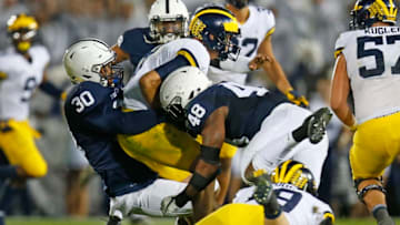 STATE COLLEGE, PA - OCTOBER 21: Kevin Givens #30 and Shareef Miller #48 of the Penn State Nittany Lions sack John O'Korn #8 of the Michigan Wolverines in the second half on October 21, 2017 at Beaver Stadium in State College, Pennsylvania. (Photo by Justin K. Aller/Getty Images)