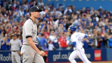 Sep 24, 2016; Toronto, Ontario, CAN New York Yankees relief pitcher Tyler Clippard (29) walks back to the mound as Toronto Blue Jays right fielder Jose Bautista (19) rounds the bases after hitting a three run home run in the eighth inning at Rogers Centre. The Jays won 3-0. Mandatory Credit: Dan Hamilton-USA TODAY Sports