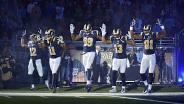 Nov 30, 2014; St. Louis, MO, USA; St. Louis Rams wide receiver Stedman Bailey (12) and wide receiver Tavon Austin (11) and tight end Jared Cook (89) and wide receiver Chris Givens (13) and wide receiver Kenny Britt (81) put their hands up to show support for Michael Brown before a game against the Oakland Raiders at the Edward Jones Dome. Mandatory Credit: Jeff Curry-USA TODAY Sports