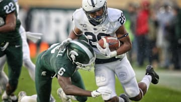 Oct 26, 2019; East Lansing, MI, USA; Penn State Nittany Lions running back Devyn Ford (28) is tackled by Michigan State Spartans safety David Dowell (6) during the first half of a game at Spartan Stadium. Mandatory Credit: Mike Carter-USA TODAY Sports