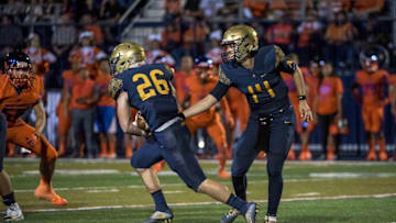 Sep 30, 2016; Las Vegas , NV, USA; St. Thomas Aquinas Raiders quarterback Jake Allen (14) hands the ball off to running back Michael Epstein (26) against the Bishop Gorman Gaels during the third quarter at Fertitta Field. Bishop Gorman won 25-24 in overtime. Mandatory Credit: Joshua Dahl-USA TODAY Sports