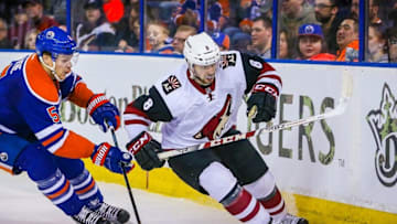 Mar 12, 2016; Edmonton, Alberta, CAN; Arizona Coyotes center Tobias Rieder (8) and Edmonton Oilers defenseman Mark Fayne (5) battle for the puck during the first period at Rexall Place. Mandatory Credit: Sergei Belski-USA TODAY Sports