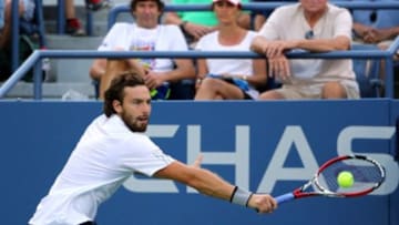 Aug 27, 2014; New York, NY, USA; Ernests Gulbis (LAT) returns a shot to Kenny De Schepper (FRA) on the Grandstand Court on day three of the 2014 U.S. Open tennis tournament at USTA Billie Jean King National Tennis Center. Mandatory Credit: Anthony Gruppuso-USA TODAY Sports