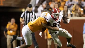 KNOXVILLE, TN - OCTOBER 05: Henry To'o To'o #11 of the Tennessee Volunteers attempts to tackle Tyler Simmons #87 of the Georgia Bulldogs during a game between University of Georgia Bulldogs and University of Tennessee Volunteers at Neyland Stadium on October 5, 2019 in Knoxville, Tennessee. (Photo by Steve Limentani/ISI Photos/Getty Images).