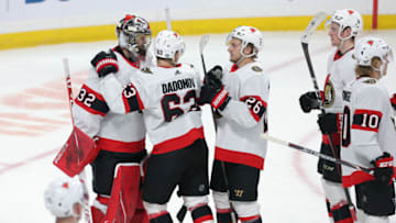 WINNIPEG, MANITOBA - MAY 08: Evgenii Dadonov #63 and Erik Brannstrom #26 of the Ottawa Senators congratulate goalie Filip Gustavsson #32 after defeating the Winnipeg Jets in NHL action on May 8, 2021 at Bell MTS Place in Winnipeg, Manitoba, Canada. (Photo by Jason Halstead/Getty Images)