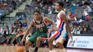 Mar 31, 2014; Auburn Hills, MI, USA; Milwaukee Bucks guard Brandon Knight (11) dribbles the ball around Detroit Pistons guard Brandon Jennings (7) during the third quarter at The Palace of Auburn Hills. Pistons won 116-111. Mandatory Credit: Tim Fuller-USA TODAY Sports