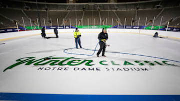 SOUTH BEND, IN - DECEMBER 28: NHL Ice Crew install the 2019 Bridgestone NHL Winter Classic logos at Notre Dame Stadium on December 28, 2018 in South Bend, Indiana. (Photo by Chase Agnello-Dean/NHLI via Getty Images)
