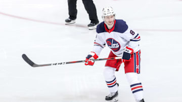 WINNIPEG, MB - FEBRUARY 26: Jacob Trouba #8 of the Winnipeg Jets keeps an eye on the play during third period action against the Minnesota Wild at the Bell MTS Place on February 26, 2019 in Winnipeg, Manitoba, Canada. The Wild defeated the Jets 3-2. (Photo by Jonathan Kozub/NHLI via Getty Images)