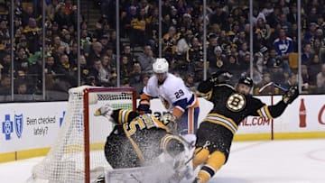 Dec 20, 2016; Boston, MA, USA; Boston Bruins defenseman Kevan Miller (86) loses his balance in front of goalie Anton Khudobin (35) while New York Islanders left wing Brock Nelson (29) looks for the puck during the third period at TD Garden. Mandatory Credit: Bob DeChiara-USA TODAY Sports