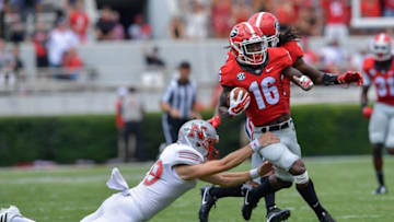 Sep 10, 2016; Athens, GA, USA; Georgia Bulldogs wide receiver Isaiah McKenzie (16) breaks a tackle by Nicholls State Colonels punter Tyler St. Germain (19) during the second half at Sanford Stadium. Georgia defeated Nicholls State 26-24. Mandatory Credit: Dale Zanine-USA TODAY Sports