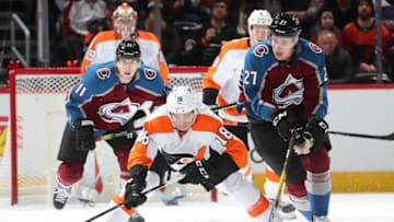 DENVER, COLORADO - DECEMBER 11: Ryan Graves #27 of the Colorado Avalanche chases the puck next to Tyler Pitlick #18 of the Philadelphia Flyers at Pepsi Center on December 11, 2019 in Denver, Colorado. (Photo by Michael Martin/NHLI via Getty Images)