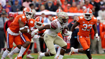 CLEMSON, SC - NOVEMBER 11: Cam Akers #3 of the Florida State Seminoles runs with the ball against the defense of the Clemson Tigers during their game at Memorial Stadium on November 11, 2017 in Clemson, South Carolina. (Photo by Streeter Lecka/Getty Images)