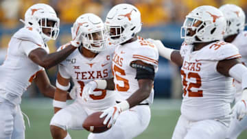 MORGANTOWN, WV - OCTOBER 05: B.J. Foster #25 of the Texas Longhorns celebrates with teammates after intercepting a pass in the second half against the West Virginia Mountaineers at Mountaineer Field on October 5, 2019 in Morgantown, West Virginia. (Photo by Joe Robbins/Getty Images)
