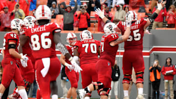 RALEIGH, NC - DECEMBER 01: Garrett Bradbury #65 of the North Carolina State Wolfpack celebrates with teammates following a one-yard touchdown run against the East Carolina Pirates in the fourth quarter at Carter-Finley Stadium on December 1, 2018 in Raleigh, North Carolina. NC State won 58-3. (Photo by Lance King/Getty Images)