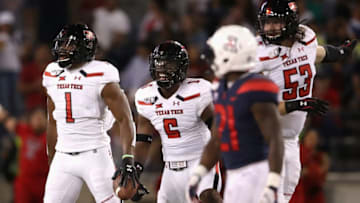 TUCSON, ARIZONA - SEPTEMBER 14: Linebacker Jordyn Brooks #1 (L) of the Texas Tech Red Raiders reacts after recovering a fumble against the Arizona Wildcats during the first half of the NCAAF game at Arizona Stadium on September 14, 2019 in Tucson, Arizona. (Photo by Christian Petersen/Getty Images)