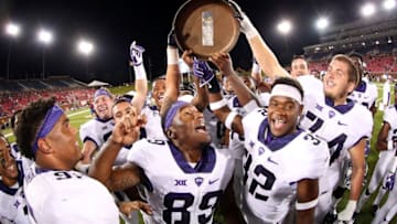 DALLAS, TX - SEPTEMBER 23: The TCU Horned Frogs celebrate with the Iron Skillet Trophy after beating the Southern Methodist Mustangs 33-3 at Gerald J. Ford Stadium on September 23, 2016 in Dallas, Texas. (Photo by Tom Pennington/Getty Images)