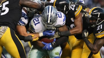Nov 13, 2016; Pittsburgh, PA, USA; Dallas Cowboys running back Ezekiel Elliott (21) is hit by Pittsburgh Steelers defenders during the first half of their game at Heinz Field. Mandatory Credit: Jason Bridge-USA TODAY Sports
