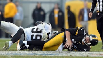 Nov 8, 2015; Pittsburgh, PA, USA; Pittsburgh Steelers quarterback Ben Roethlisberger (7) suffers an injury after a sack by Oaklanld Raiders defensive end Aldon Smith (99) in the fourth quarter in a NFL football game at Heinz Field. Mandatory Credit: Kirby Lee-USA TODAY Sports