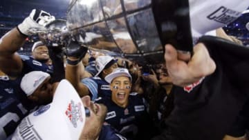 November 25, 2012; Toronto, ON, Canada; Toronto Argonauts wide receiver Chad Owens (2) reacts as a teammate hoists the Grey Cup after the game against the Calgary Stampeders at the Rogers Centre. Toronto defeated Calgary Stampeders 35-22. Mandatory Credit: John E. Sokolowski-USA TODAY Sports
