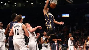 Dec 27, 2014; Brooklyn, NY, USA; Indiana Pacers point guard George Hill (3) dunks over Brooklyn Nets center Mason Plumlee (1) and Brooklyn Nets shooting guard Sergey Karasev (10) during the third quarter at Barclays Center. The Pacers defeated the Nets 110-85. Mandatory Credit: Brad Penner-USA TODAY Sports