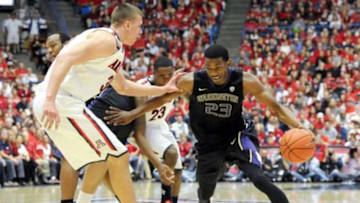 Jan 4, 2014; Tucson, AZ, USA; Washington Huskies guard C.J. Wilcox (23) dribbles the ball as he is defended by Arizona Wildcats center Kaleb Tarczewski (35) during the first half at McKale Center. Mandatory Credit: Casey Sapio-USA TODAY Sports