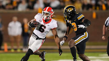 COLUMBIA, MO - OCTOBER 01: Kenny McIntosh #6 of the Georgia Bulldogs runs the ball against Martez Manuel #3 of the Missouri Tigers during the second half at Faurot Field/Memorial Stadium on October 1, 2022 in Columbia, Missouri. Georgia defeated Missouri 26-22. (Photo by Jay Biggerstaff/Getty Images)