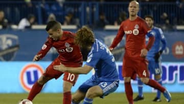 Oct 29, 2015; Montreal, Quebec, CAN; Toronto FC forward Sebastian Giovinco (10) plays the ball and Montreal Impact midfielder Marco Donadel (33) defends during the second half of a knockout round match of the 2015 MLS Cup Playoffs at Stade Saputo. Mandatory Credit: Eric Bolte-USA TODAY Sports