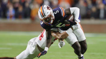 Auburn footballOct 30, 2021; Auburn, Alabama, USA; Auburn Tigers wide receiver Kobe Hudson (5) is tackled by Mississippi Rebels defensive back Deane Leonard (24) during the first quarter at Jordan-Hare Stadium. Mandatory Credit: John Reed-USA TODAY Sports