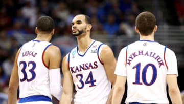 Mar 26, 2016; Louisville, KY, USA; Kansas Jayhawks forward Perry Ellis (34) reacts with forward Landen Lucas (33) and Sviatoslav Mykhailiuk against the Villanova Wildcats during the first half of the south regional final of the NCAA Tournament at KFC YUM!. Mandatory Credit: Aaron Doster-USA TODAY Sports