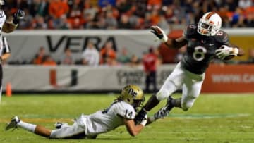 Nov 29, 2014; Miami Gardens, FL, USA; Miami Hurricanes running back Duke Johnson (8) carries the ball as Pittsburgh Panthers defensive back Avonte Maddox (14) defends during the first half at Sun Life Stadium. Mandatory Credit: Steve Mitchell-USA TODAY Sports