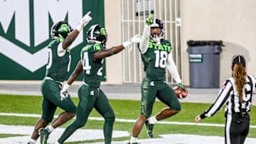Michigan State's Kalon Gervin, right, celebrates a touchdown on a recovered Northwestern fumble during the fourth quarter on Saturday, Nov. 28, 2020, at Spartan Stadium in East Lansing.201128 Msu Northwestern 199a