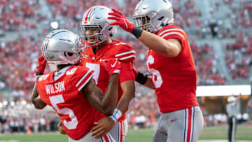 COLUMBUS, OHIO - SEPTEMBER 18: Wide receiver Garrett Wilson #5 of the Ohio State Buckeyes celebrates a touchdown with quarterback C.J. Stroud #7 and tight end Cade Stover #16 of the Ohio State Buckeyes in the fourth quarter against the Tulsa Golden Hurricane at Ohio Stadium on September 18, 2021 in Columbus, Ohio. (Photo by Gaelen Morse/Getty Images)