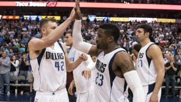 Apr 6, 2016; Dallas, TX, USA; Dallas Mavericks forward David Lee (42) and guard Wesley Matthews (23) celebrate the win over the Houston Rockets at the American Airlines Center. The Mavericks defeat the Rockets 88-86. Mandatory Credit: Jerome Miron-USA TODAY Sports