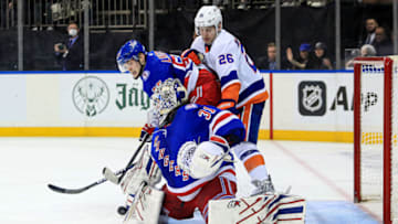 Mar 17, 2022; New York, New York, USA; New York Rangers goaltender Igor Shesterkin (31) makes a save while New York Rangers defenseman Ryan Lindgren (55) and New York Islanders right wing Oliver Wahlstrom (26) get tangled up during the third period at Madison Square Garden. Mandatory Credit: Danny Wild-USA TODAY Sports