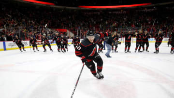 RALEIGH, NC - OCTOBER 26: Brock McGinn #23 of the Carolina Hurricanes leads the team in a celebration after their victory over the San Jose Sharks following an NHL game on October 26, 2018 at PNC Arena in Raleigh, North Carolina. (Photo by Gregg Forwerck/NHLI via Getty Images