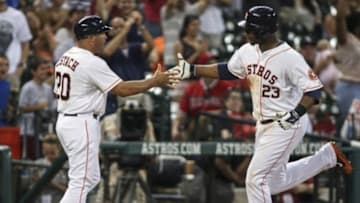 Sep 3, 2014; Houston, TX, USA; Houston Astros designated hitter Chris Carter (23) celebrates with third base coach Pat Listach (20) after hitting a home run during the eighth inning against the Los Angeles Angels at Minute Maid Park. Mandatory Credit: Troy Taormina-USA TODAY Sports