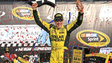 Aug 16, 2015; Brooklyn, MI, USA; NASCAR Sprint Cup Series driver Matt Kenseth (20) celebrates in victory lane after winning the Pure Michigan 400 at Michigan International Speedway. Mandatory Credit: Andrew Weber-USA TODAY Sports