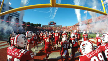 RALEIGH, NC - NOVEMBER 03: Players of the North Carolina State Wolfpack run onto the field as planes fly overhead prior to their game against the Florida State Seminoles at Carter-Finley Stadium on November 3, 2018 in Raleigh, North Carolina. (Photo by Lance King/Getty Images)