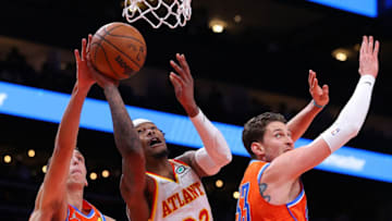 Cam Reddish #22 of the Atlanta Hawks drives against Aleksej Pokusevski #17 and Mike Muscala #33 of the Oklahoma City Thunder during the second half at State Farm Arena on November 22, 2021 in Atlanta, Georgia. NOTE TO USER: User expressly acknowledges and agrees that, by downloading and or using this photograph, User is consenting to the terms and conditions of the Getty Images License Agreement. (Photo by Kevin C. Cox/Getty Images)