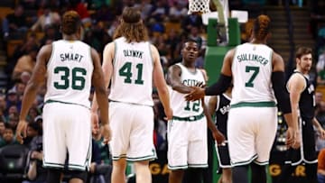 Oct 19, 2015; Boston, MA, USA; Boston Celtics guard Terry Rozier (12) and forward Jared Sullinger (7) celebrate as guard Marcus Smart (36) and center Kelly Olynyk (41) look on during the first half of a game against the Brooklyn Nets at TD Garden. Mandatory Credit: Mark L. Baer-USA TODAY Sports