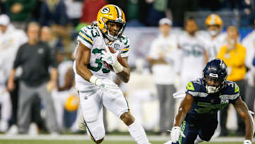 SEATTLE, WA - NOVEMBER 15: Aaron Jones #33 of the Green Bay Packers avoids a tackle by Tre Flowers #37 of the Seattle Seahawks in the second half at CenturyLink Field on November 15, 2018 in Seattle, Washington. (Photo by Otto Greule Jr/Getty Images)