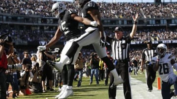 Oct 9, 2016; Oakland, CA, USA; Oakland Raiders wide receiver Michael Crabtree (15) is congratulated by tight end Mychal Rivera (81) after catching a touchdown pass against the San Diego Chargers in the third quarter at Oakland Coliseum. The Raiders defeated the Chargers 34-31. Mandatory Credit: Cary Edmondson-USA TODAY Sports