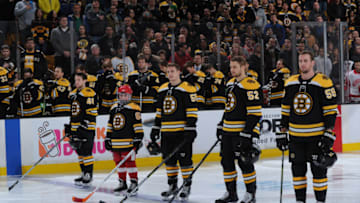 BOSTON, MA - DECEMBER 23: Kids captain stands on the blue line with Matt Grzelcyk