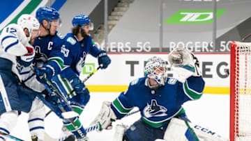 VANCOUVER, BC - APRIL 18: Alex Galchenyuk #12 of the Toronto Maple Leafs, Bo Horvat #53 and Jalen Chatfield #63 of the Vancouver Canucks watches the shot of Auston Matthews #34 of the Toronto Maple Leafs ring off the goal post behind goalie Braden Holtby #49 of the Vancouver Canucks during the third period of NHL hockey action at Rogers Arena on April 17, 2021 in Vancouver, Canada. (Photo by Rich Lam/Getty Images)